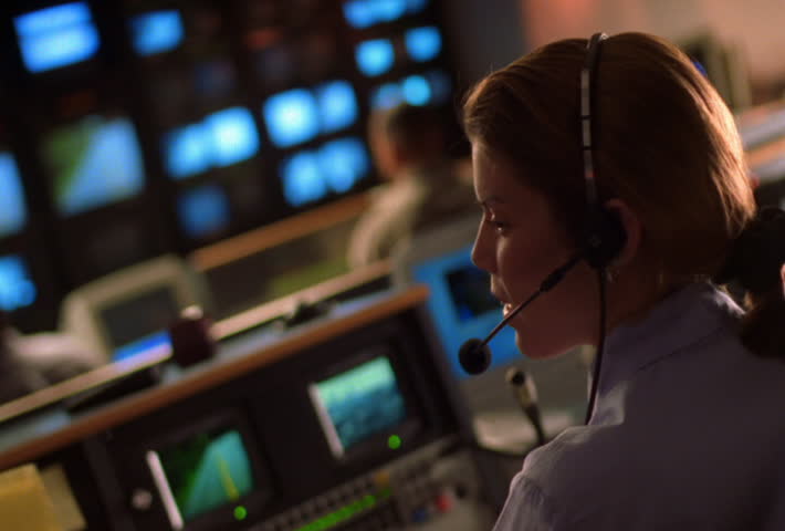 Newsroom action with producers and monitors 