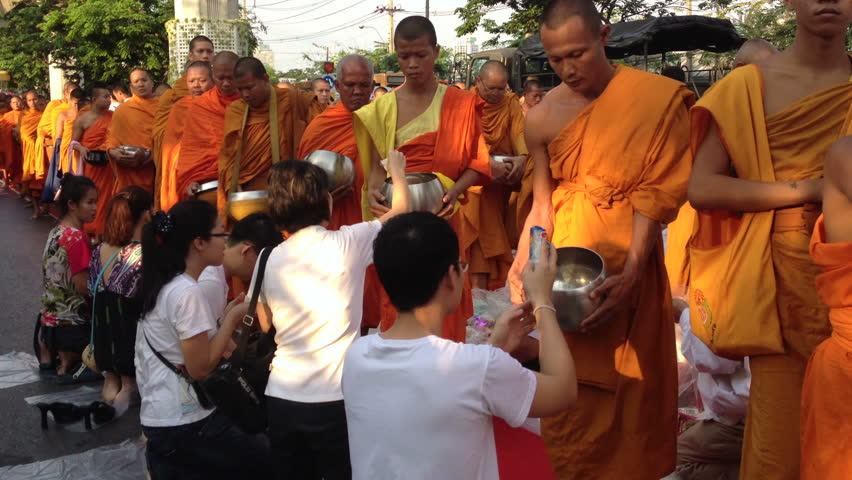 BANGKOK - MARCH 17: Monks are participating in a Mass Alms Giving of 12,600 monks for the Makha Bucha celebrations on March 17, 2012 in Bangkok, Thailand.