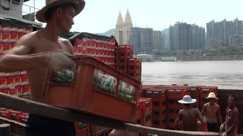 CHONGQING - 17 AUGUST: People are loading beer crates onto a cargo ship  on August 17, 2010 in Chongqing, China 