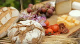wine glass, blue cheese gouda bread grape food parmesan swiss dairy healthy france milk on table dolly shot outdoors in a vineyard 
