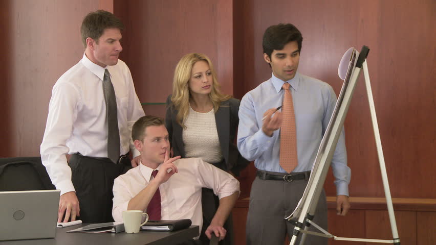 Young business man making presentation to coworkers