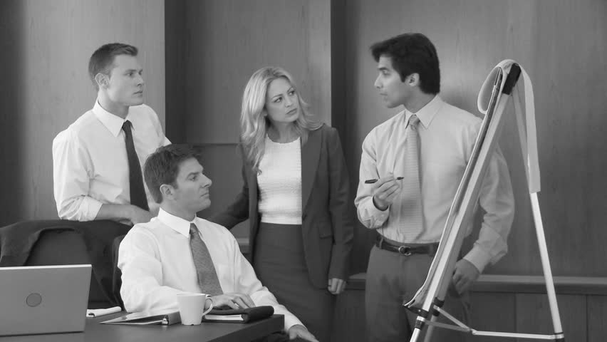 Young business man making presentation to coworkers