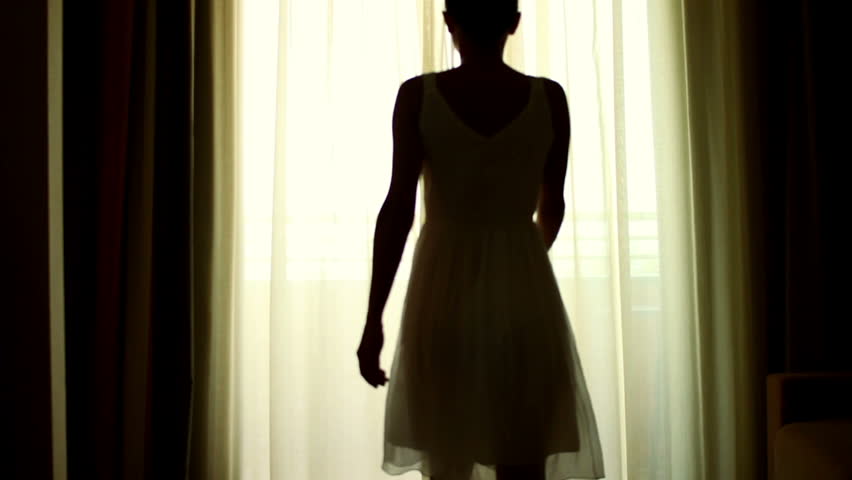 Girl opens the curtains in the morning and go out to the terrace, slow motion