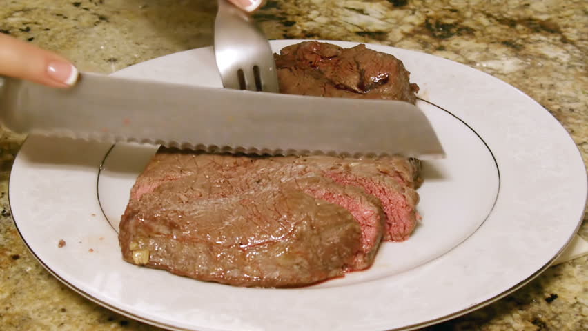 Bloody Sirloin Steak Cut (HD). Sirloin steak cut in slices showing some rare characteristics like blood. 