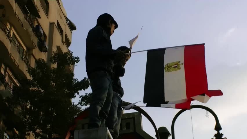 CAIRO - NOV 19: Two protesters in Tahrir Square wave egyptian flag on November 19, 2011 in Cairo, Egypt.