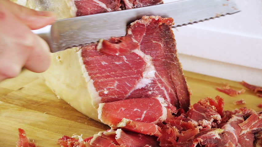 Serrano Ham Leg Carved (HD). Boneless Pork Serrano or prosciutto ham leg carved on a wood board. These ham "Jamon" legs are a Spanish delicacy and sold from 100 to thousands of dollars.