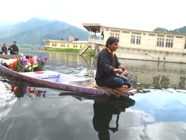SRINAGAR, INDIA - APRIL 14: Mr. Wonderful Flower Man sells flowers from his small boat on April 14, 2012 in Dal Lake, Srinagar, Jammu and Kashmir, India.