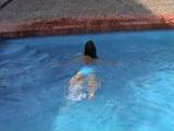 Woman swimming in the swimming pool