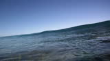 Two ocean waves in slow motion breaking near the beach in Hawaii.