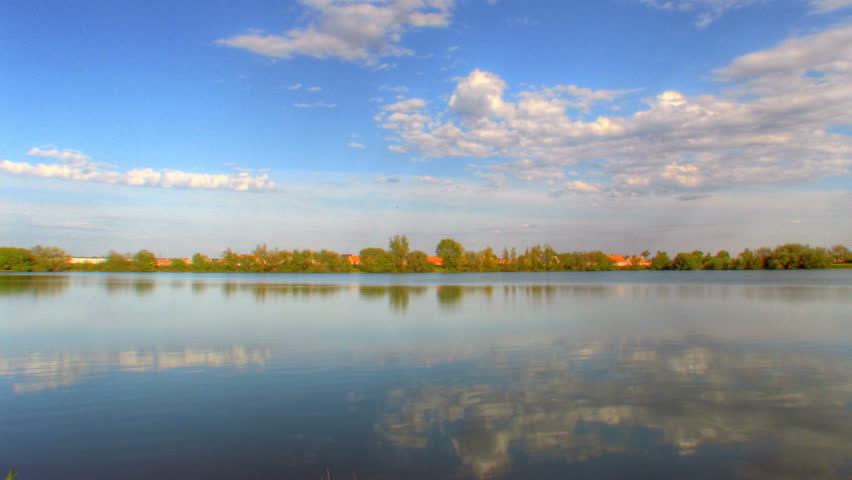 Reflexions of clouds over water, HD time lapse clip, high dynamic range imaging (hdr)