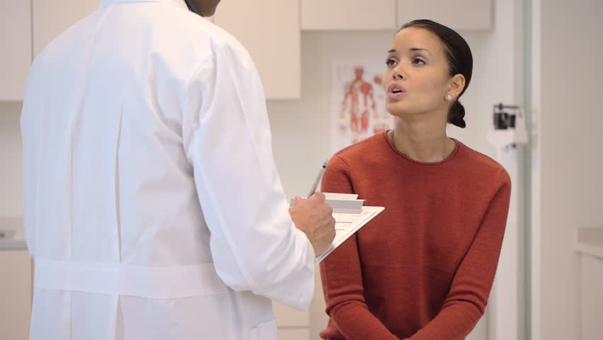 Doctor consulting patient in exam room