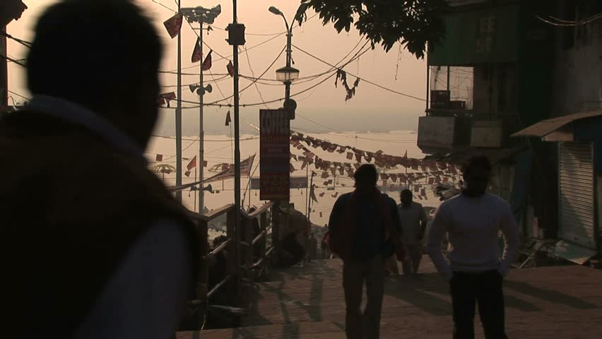 View of Ganges river from sidewalk above stairs leading down to river.Circa November, 2008, Veranasi, India