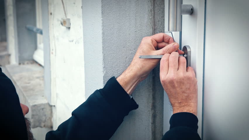 Intruder Or Burglar With Lock Pick Tool Opens The Front Door To ... Intruder Or Burglar With Lock Pick Tool Opens The Front Door To ...