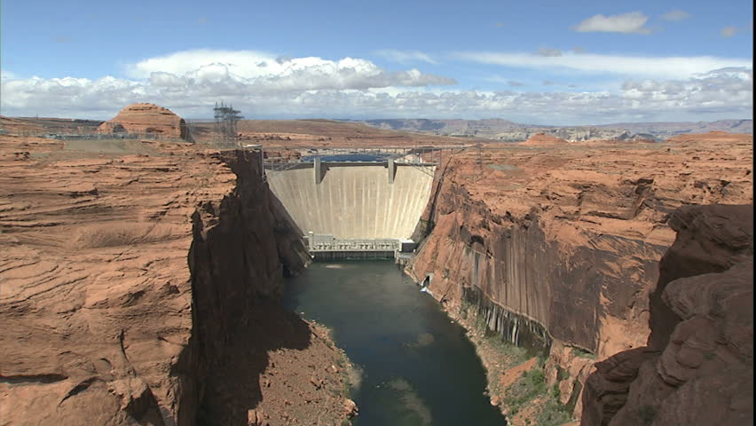 glen canyon dam and Colorado river, zoom down to river and boats parked where anglers are fly fishing for rainbow trout