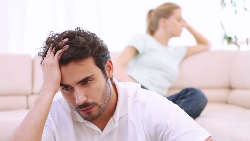 Young couple are upset after a fight in their living room
