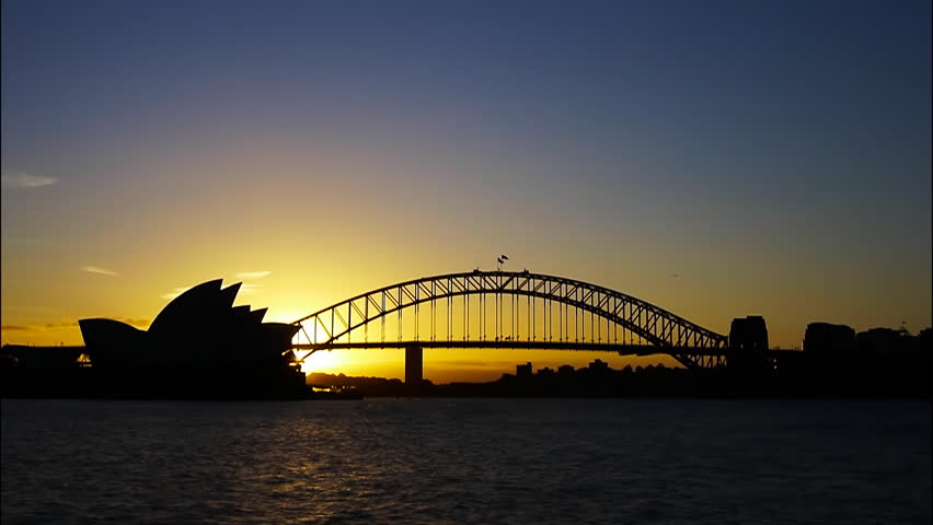 a time lapse of the sun setting on Sydney Harbour
