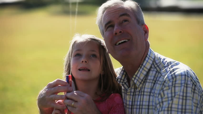 Daddy and girl flying a kite