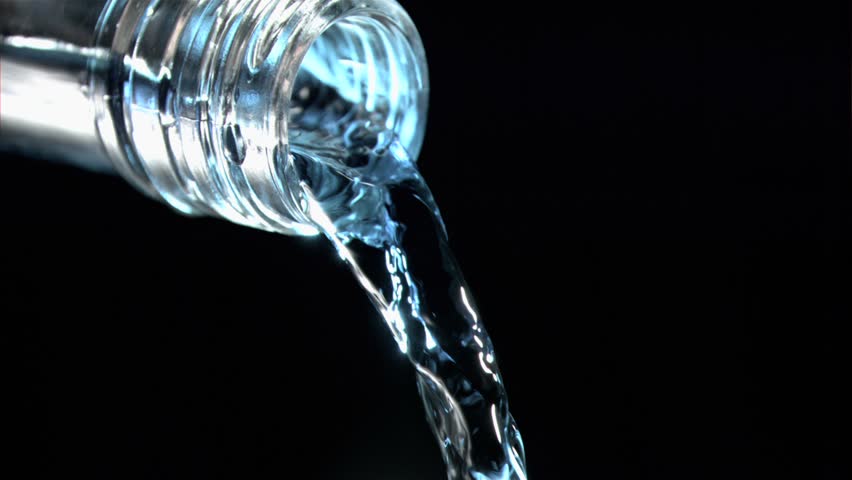 Close up,trickle of water in a super slow motion flowing of the glass bottleneck with blue reflexion against a black background