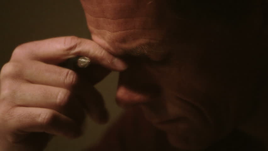 close up of a man hand writing in check book register