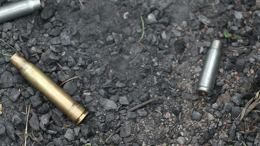 spent ammunition cartridges falling from a rifle