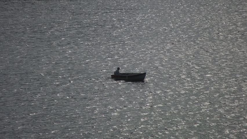 A tiny boat on a big lake.