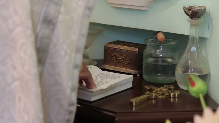 The priest reads the prayer from the Bible