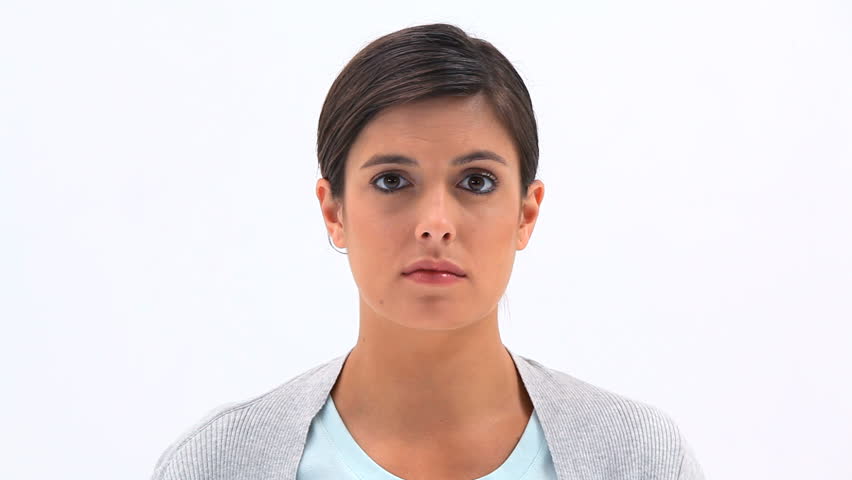 Brunette woman is sneezing against white background