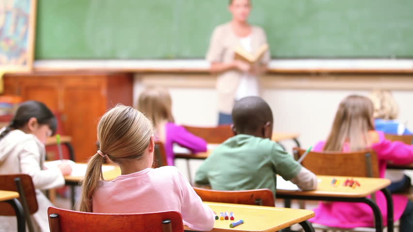 Cute children raising their fingers in the classroom