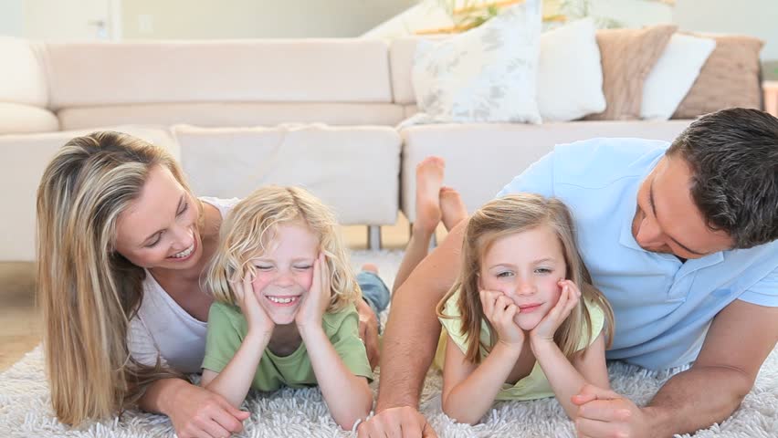 Happy family lying on the floor in the living room