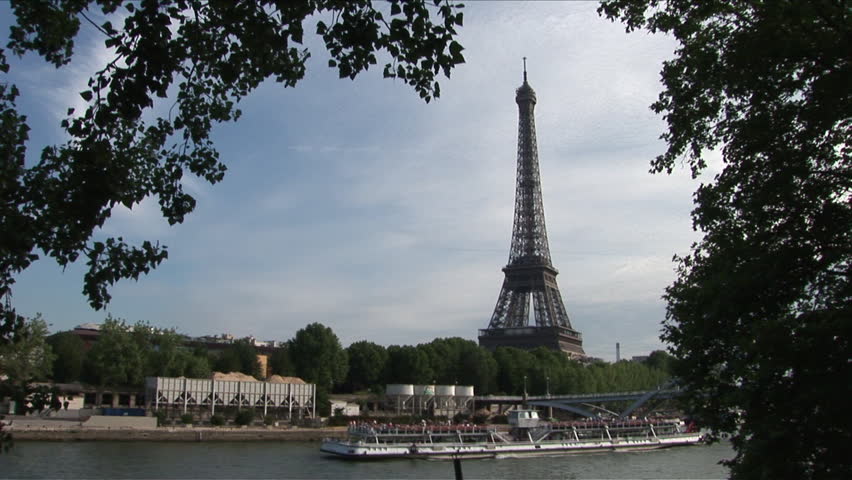View of Debilly Footbridge and Eiffel Tower in Paris France framed in trees