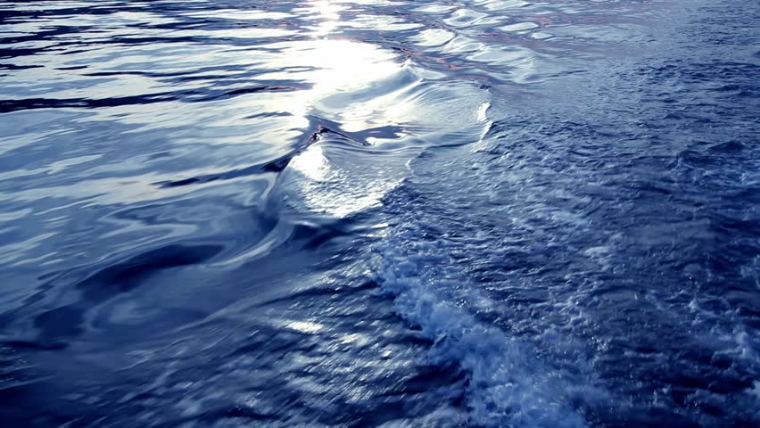 Boat prop wash wake foam texture in blue sea