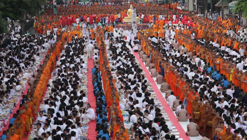 BANGKOK - MARCH 18: Monks are participating in a Mass Alms Giving of 12,600 monks for the Makha Bucha celebrations on March 18, 2012 in Bangkok, Thailand.