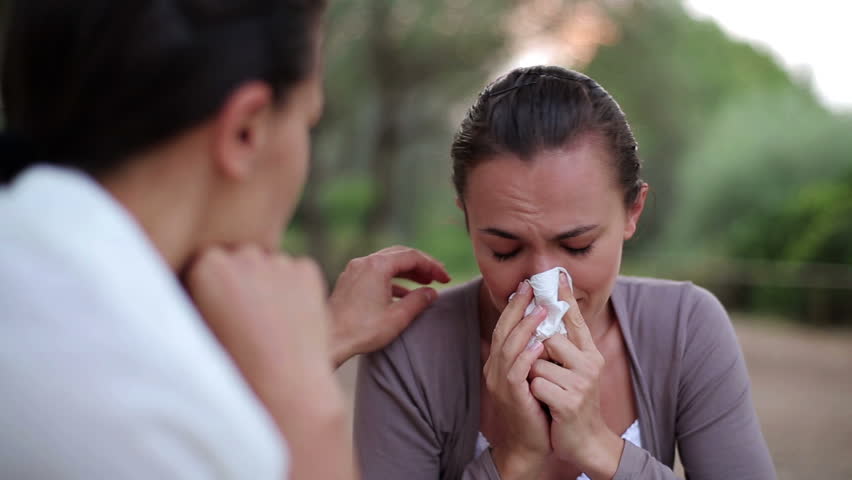 Female friend comforting sad woman, outdoor
