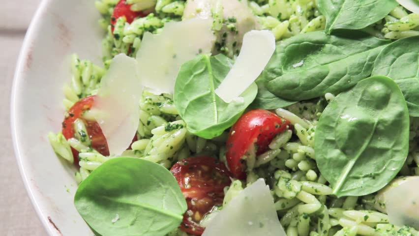 Chicken orzo salad sprinkled with freshly grated Parmesan