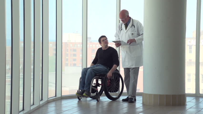 Man in wheelchair walking with doctor