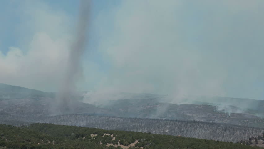 FOUNTAIN GREEN, SANPETE, UTAH 25 JUN 2012:Tornado whirlwind spins across mountain forest fire. Forest wildfire intense flames smoke. Dangerous blaze destroyed dozens of home, Wood Hollow Utah. FEMA