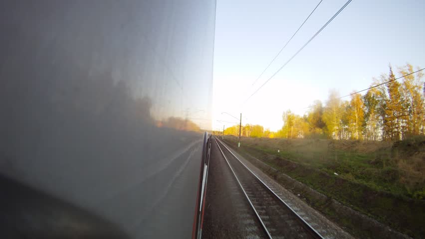 Train goes along forest belt and rural areas, time lapse