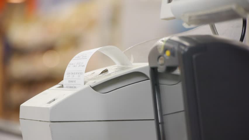 female hand takes checks from the cash register