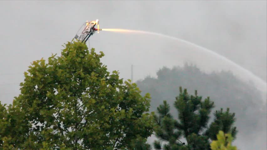 Water From Remote Control Water Cannon On Ladder Spraying Water At Long Range
