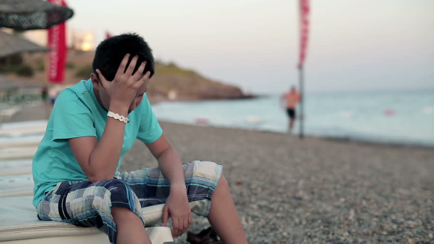 Young angry teenager on the beach
