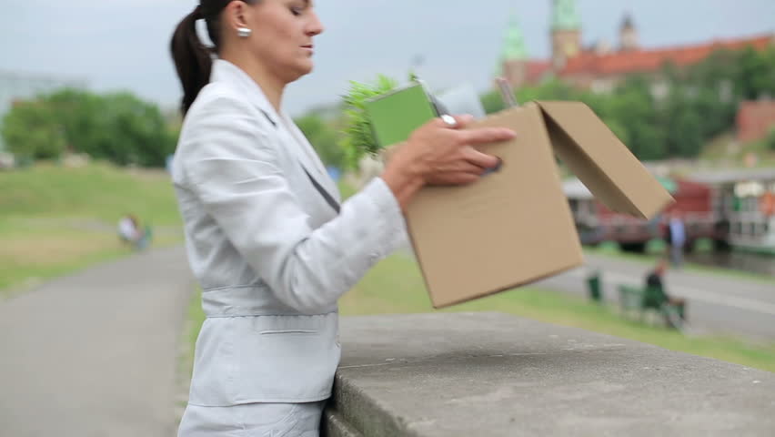 Just fired, unemployed sad young businesswoman standing in the city

