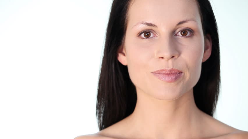 Beautiful young woman looking left.  Over white background.
