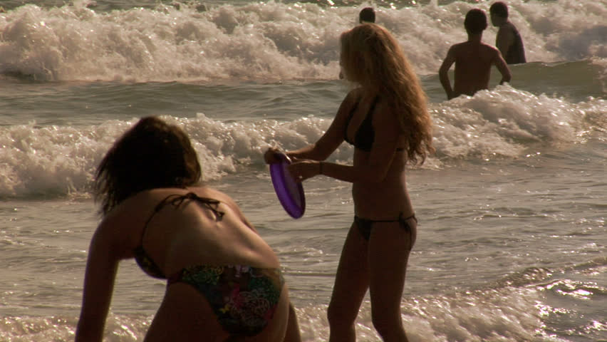 Woman throws frisbee in slow motion