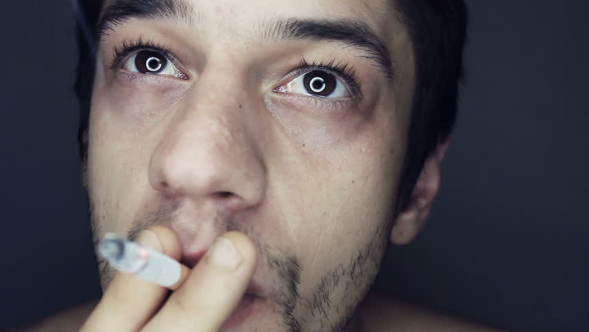 Smoking slow motion inhalation close up