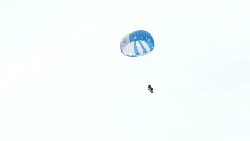 FREEDOM, SANPETE, UTAH 12 JUL 2012: Parachute smoke jumper deploys to forest fire. Wildfire burns through National Forest with smoke jumpers and fire fighting aircraft respond to the emergency.