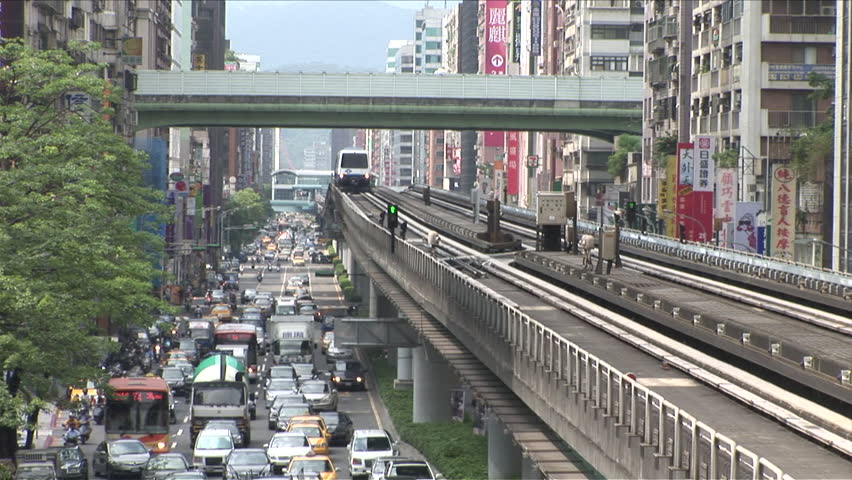 Taipei, Taiwan - CIRCA June, 2007: An elevated train comes towards the camera as it passes the traffic below it