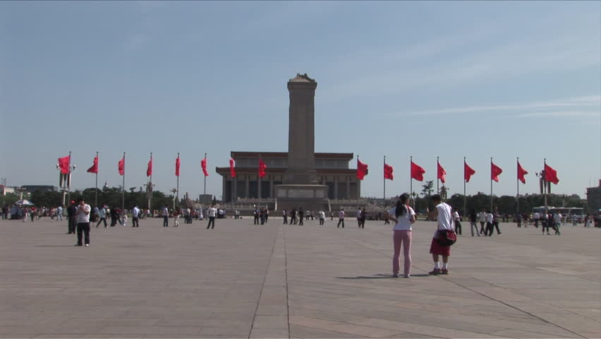 Beijing, China - CIRCA May, 2007: Wide shot People walking around Tiananmen Square with the Monument of the Heroes of the Revolution in the background