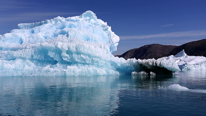 Drifting by an iceberg floating in Qooroq Icefjord, South Greenland