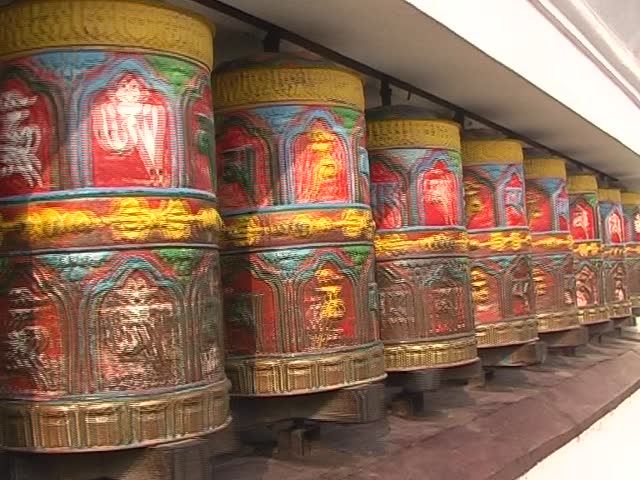 Row of Buddha copper prayer wheels.