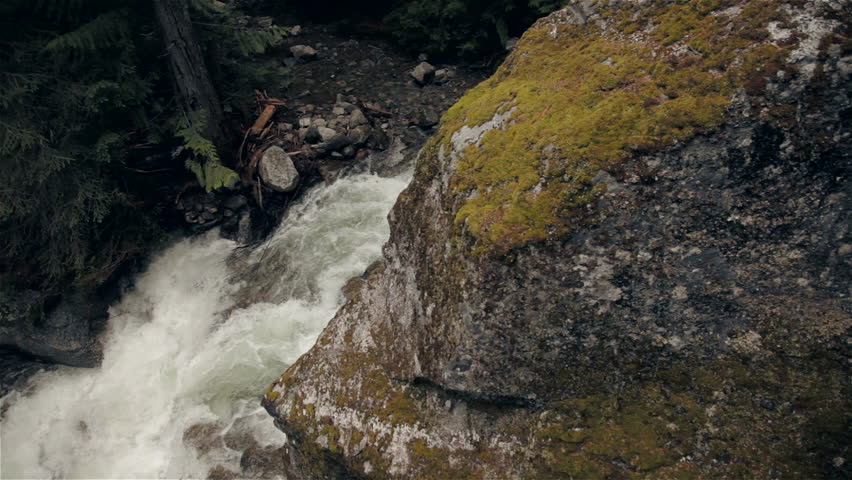 Crane move over a Creek in the Mountains